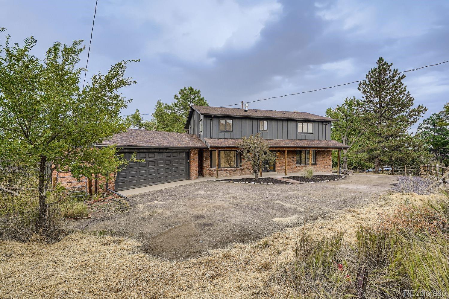 2127 Elderberry Road Golden, CO 80401 - Photo 32 of 43 a front view of a house with a yard and garage