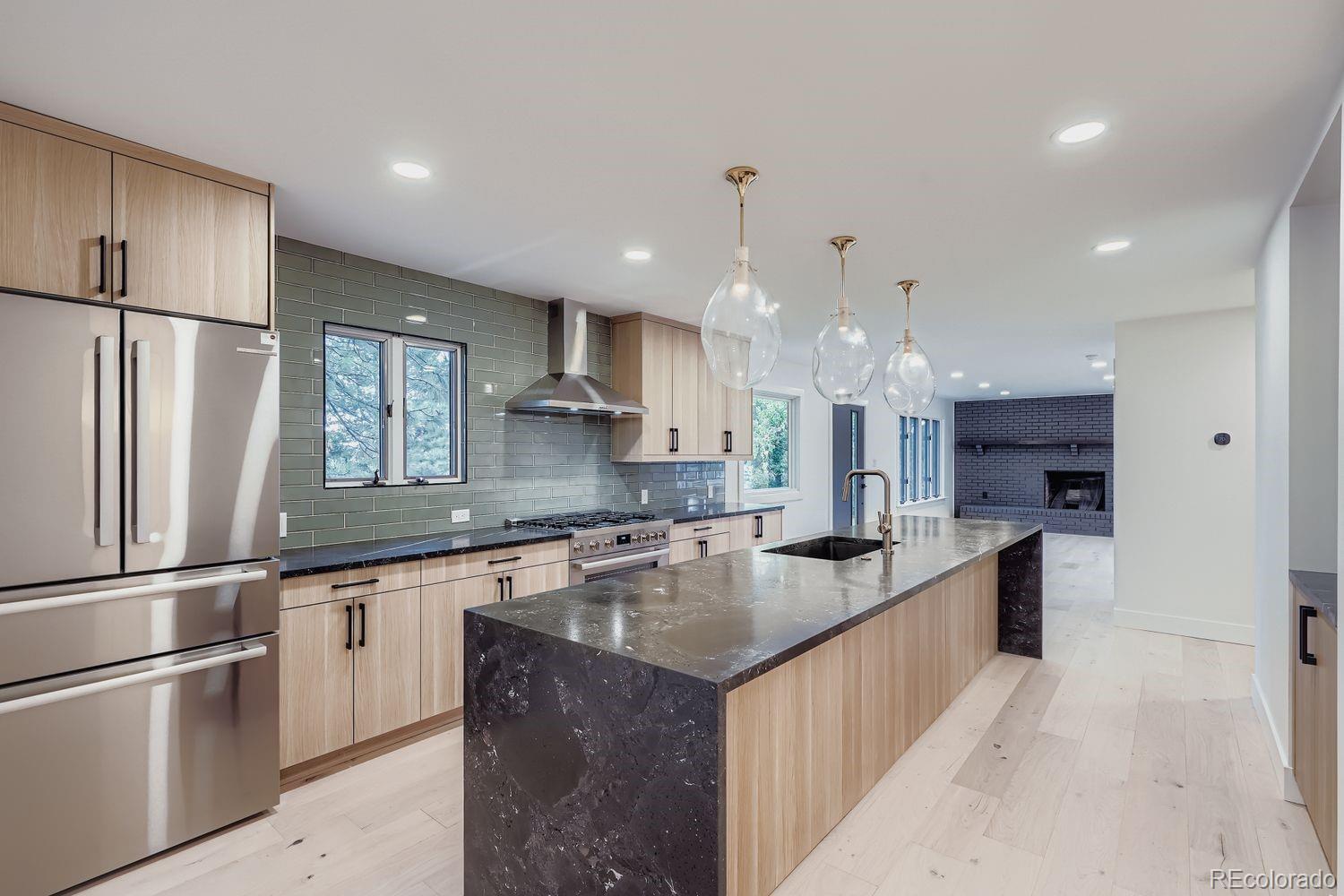 2127 Elderberry Road Golden, CO 80401 - Photo 6 of 43 a kitchen with stainless steel appliances granite countertop a sink stove and refrigerator