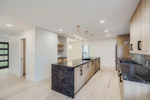 a large kitchen with stainless steel appliances granite countertop a large counter top and a stove