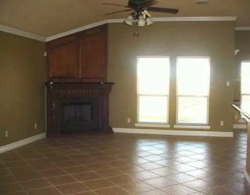 a view of a livingroom with a fireplace and window