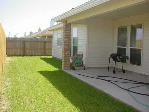 a view of backyard with patio