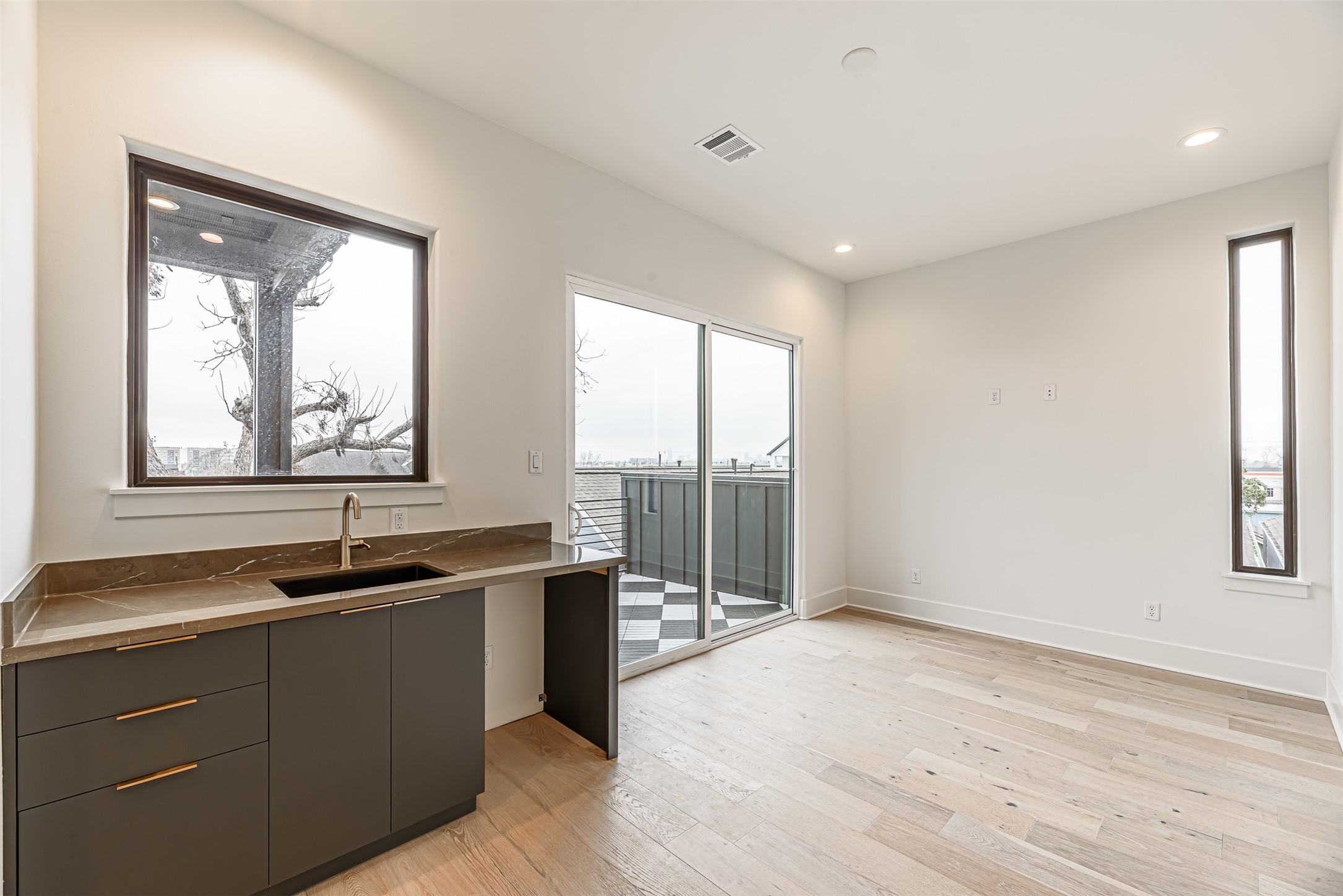 1104 West 9th Street Houston, TX 77007 - Photo 23 of 25 a kitchen with a sink and large window