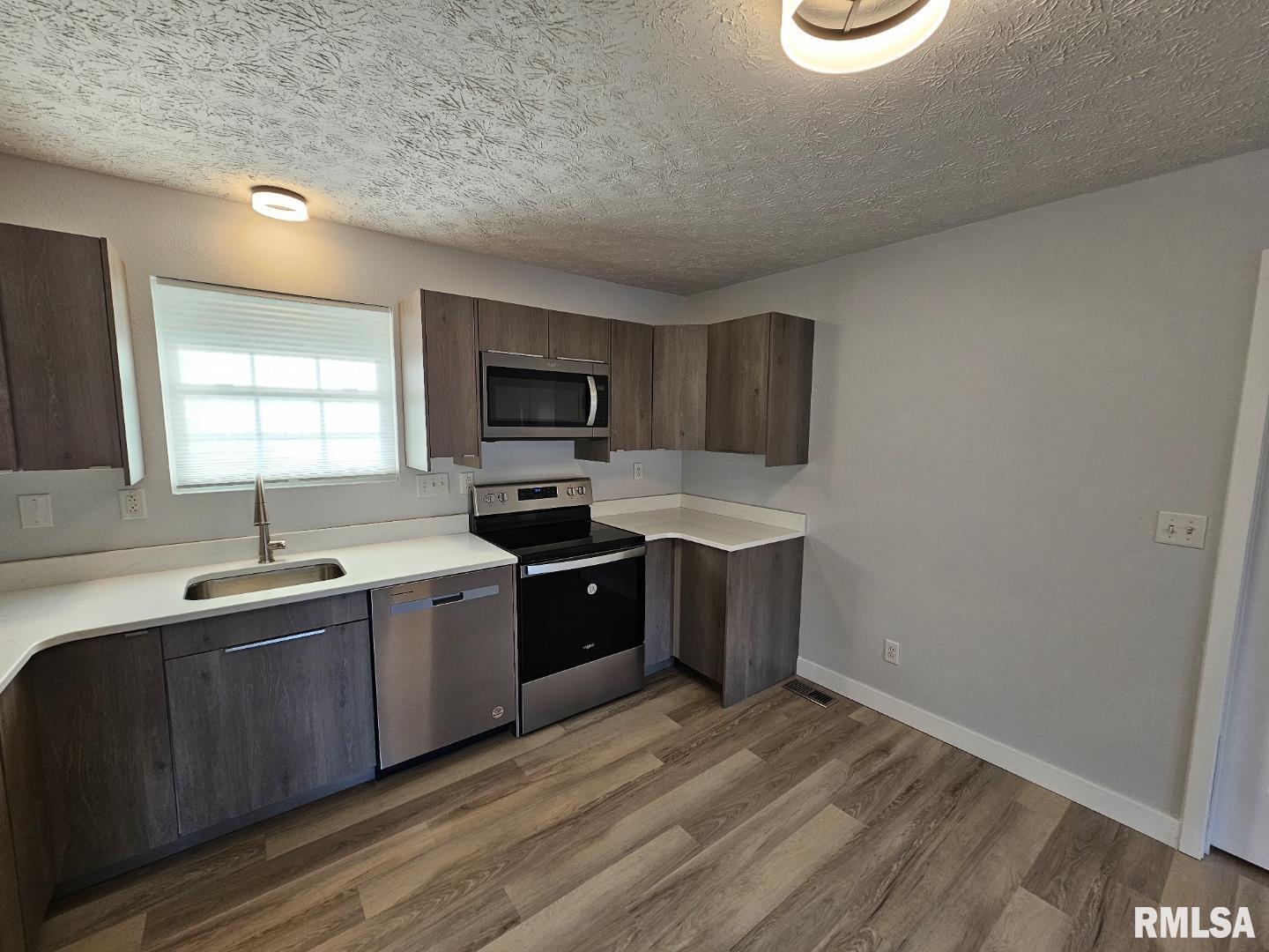 10457 Puckett Lane Mount Vernon, IL 62864 - Photo 16 of 25 a kitchen with a sink cabinets and window