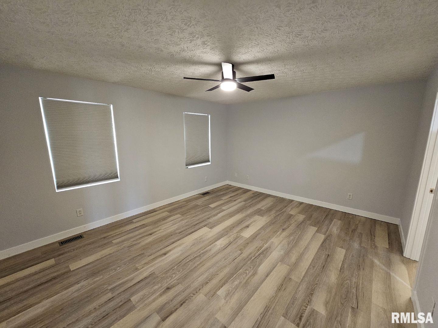 10457 Puckett Lane Mount Vernon, IL 62864 - Photo 23 of 25 wooden floor in an empty room with a window