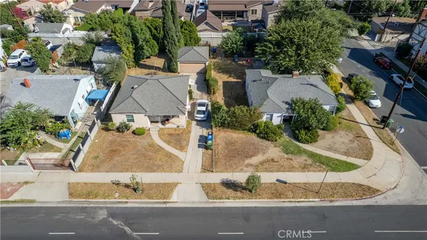 an aerial view of a house with a yard and lake view
