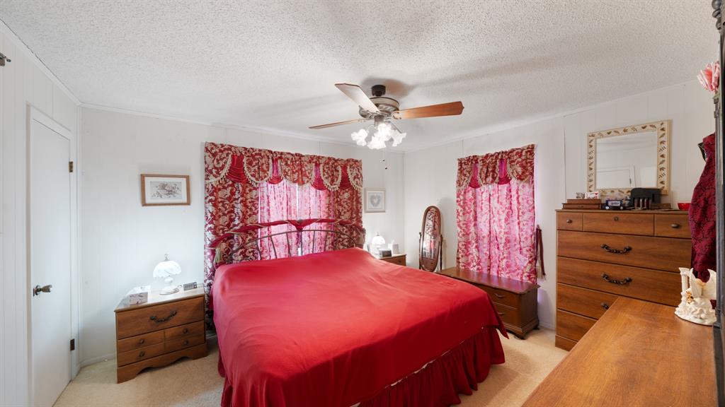 460 VZ County Road Canton, TX 75103 - Photo 18 of 24 3rd bedroom with light colored carpet, a ceiling fan, a textured ceiling, and crown molding