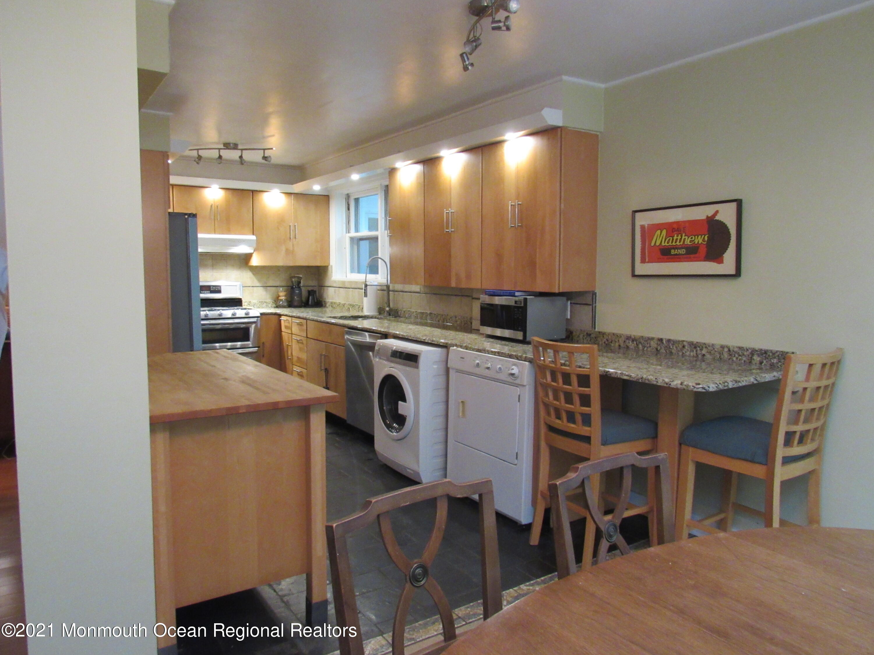17 Pine Drive Roosevelt, NJ 08555 - Photo 12 of 22 a kitchen with a stove a table and chairs