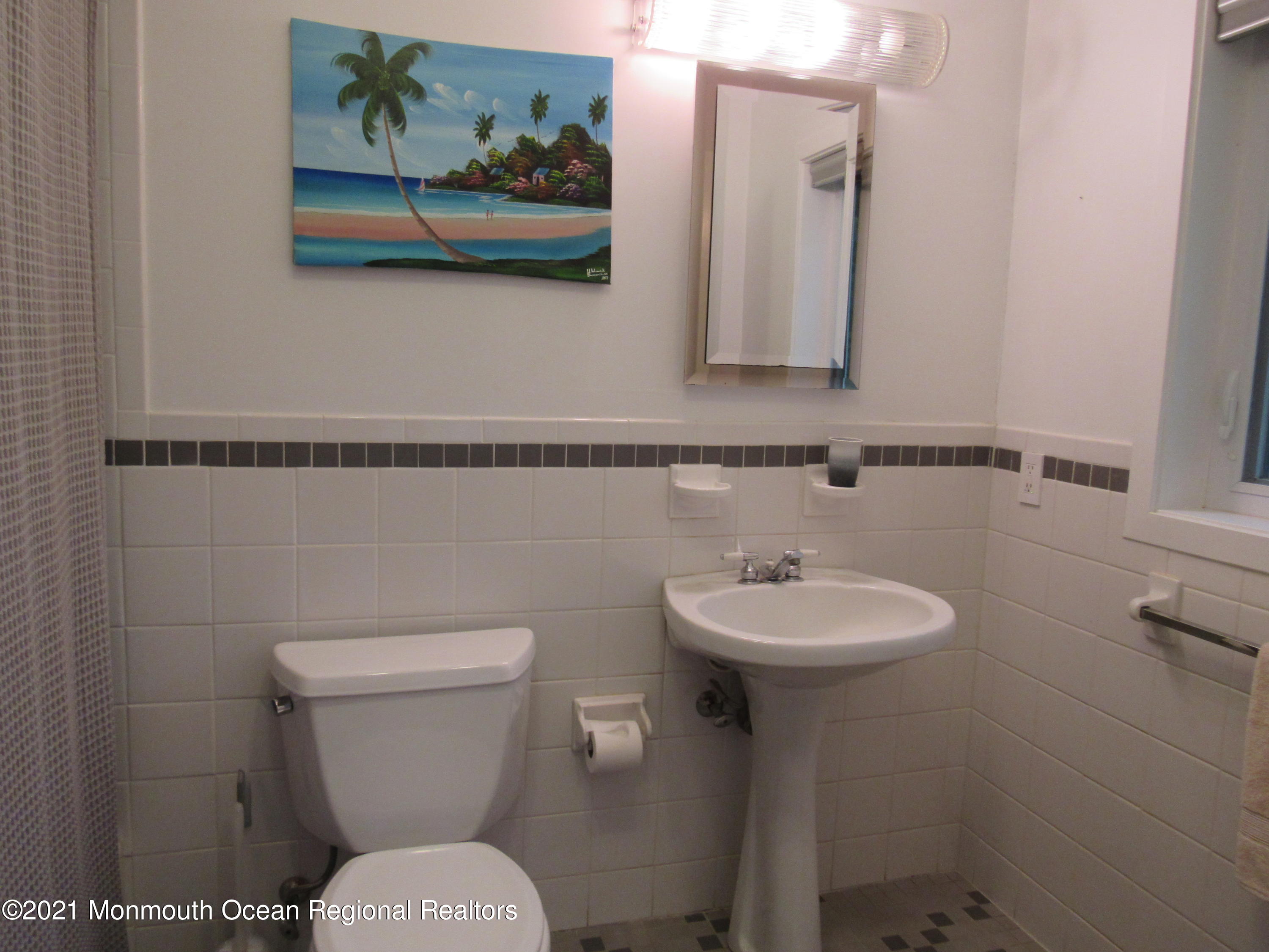 17 Pine Drive Roosevelt, NJ 08555 - Photo 19 of 22 a bathroom with a toilet a sink and mirror