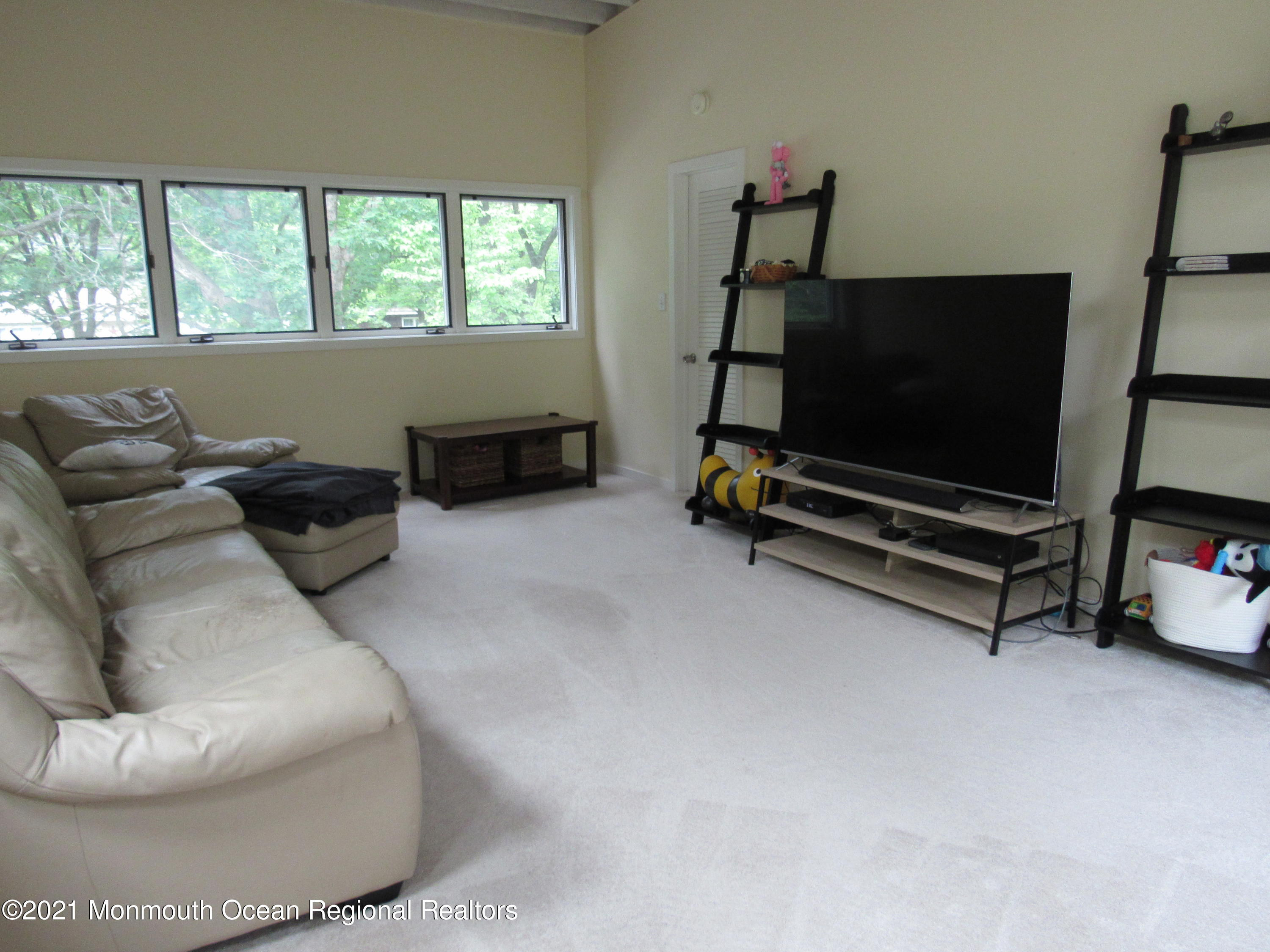 17 Pine Drive Roosevelt, NJ 08555 - Photo 21 of 22 a living room with furniture a flat screen tv and a window