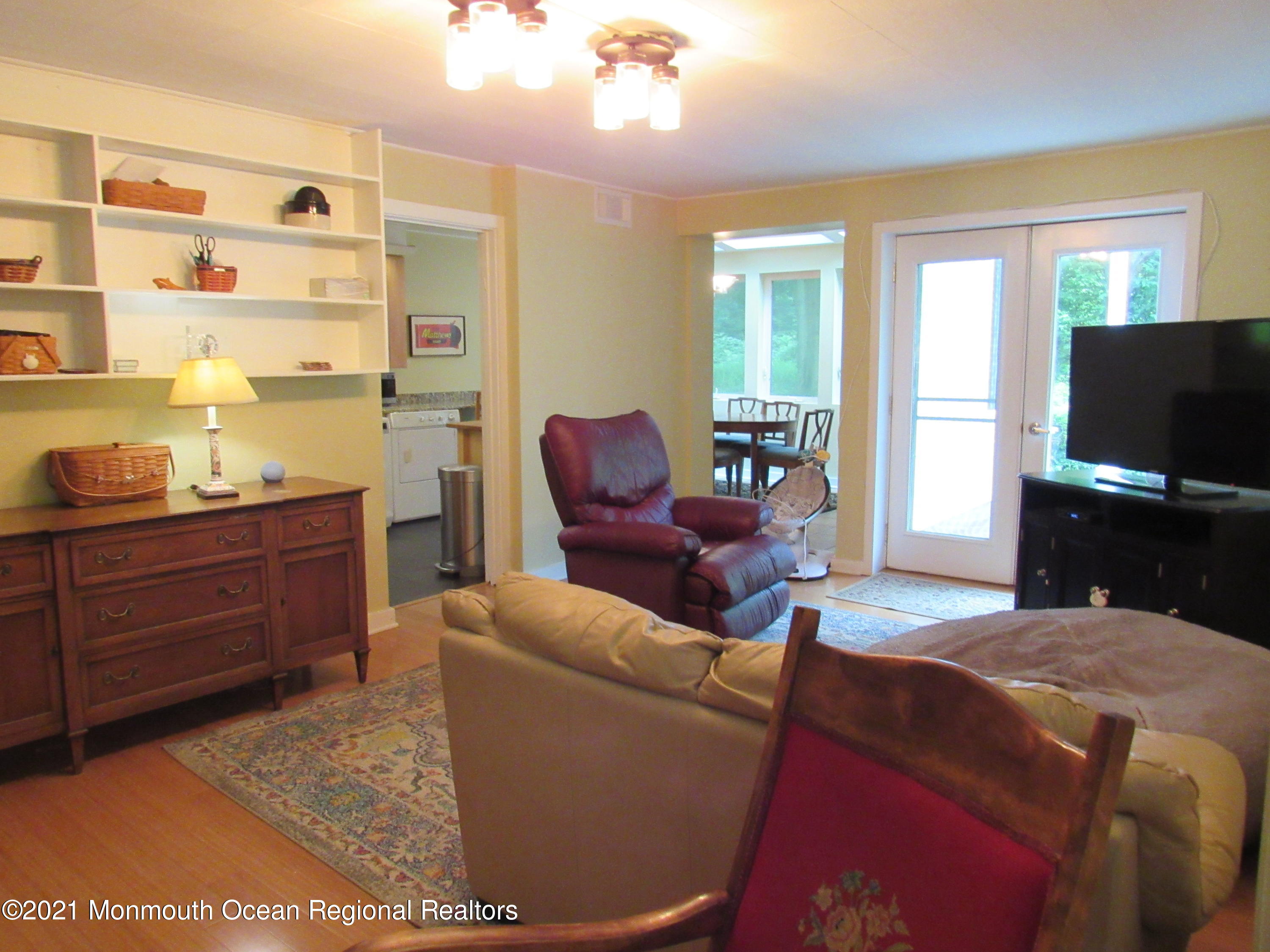 17 Pine Drive Roosevelt, NJ 08555 - Photo 10 of 22 a living room with furniture a window and a flat screen tv