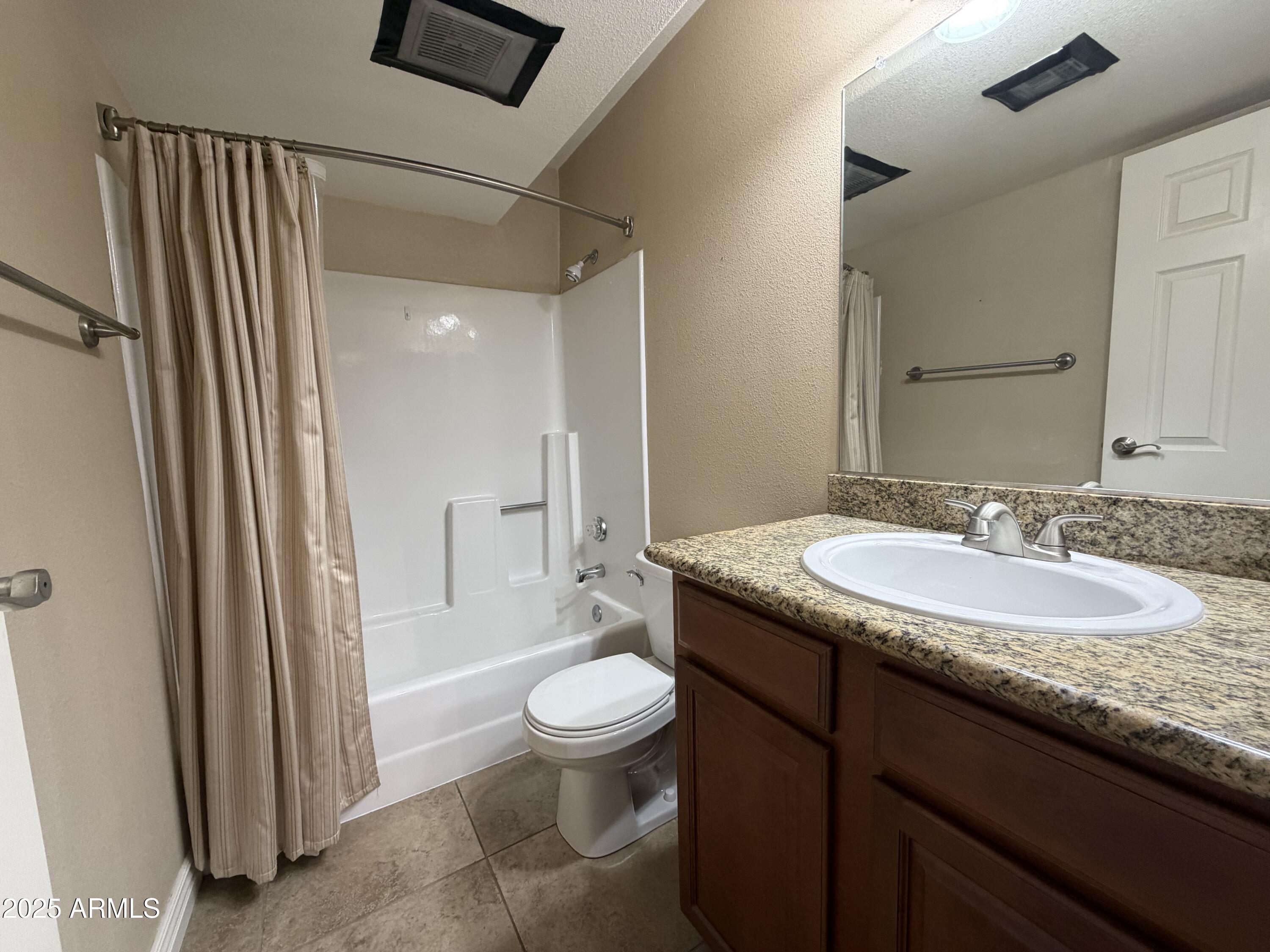 835 North Granite Reef Road, Unit 34 Scottsdale, AZ 85257 - Photo 13 of 13 a bathroom with a granite countertop sink toilet and shower
