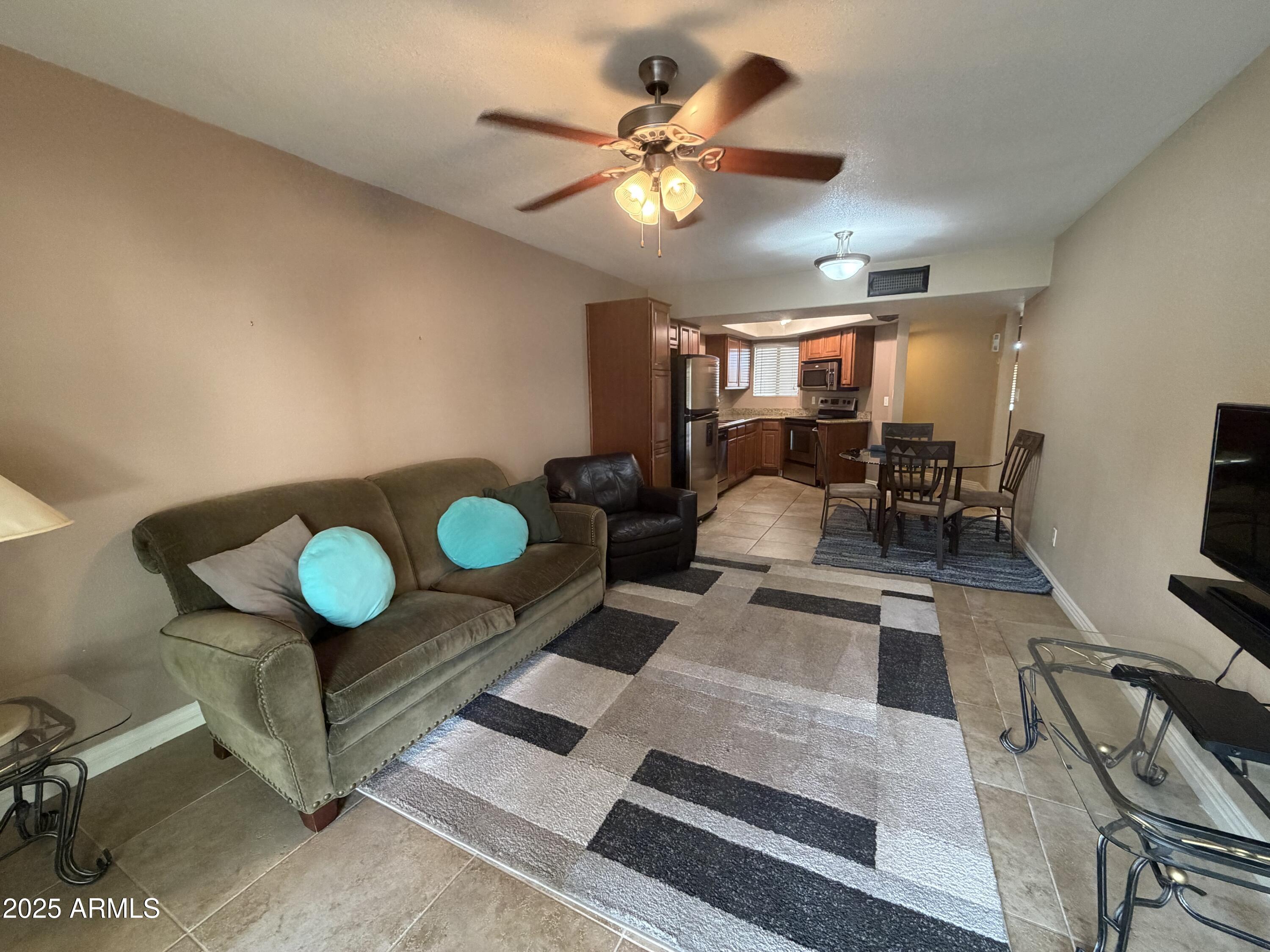 835 North Granite Reef Road, Unit 34 Scottsdale, AZ 85257 - Photo 4 of 13 a living room with furniture and a table