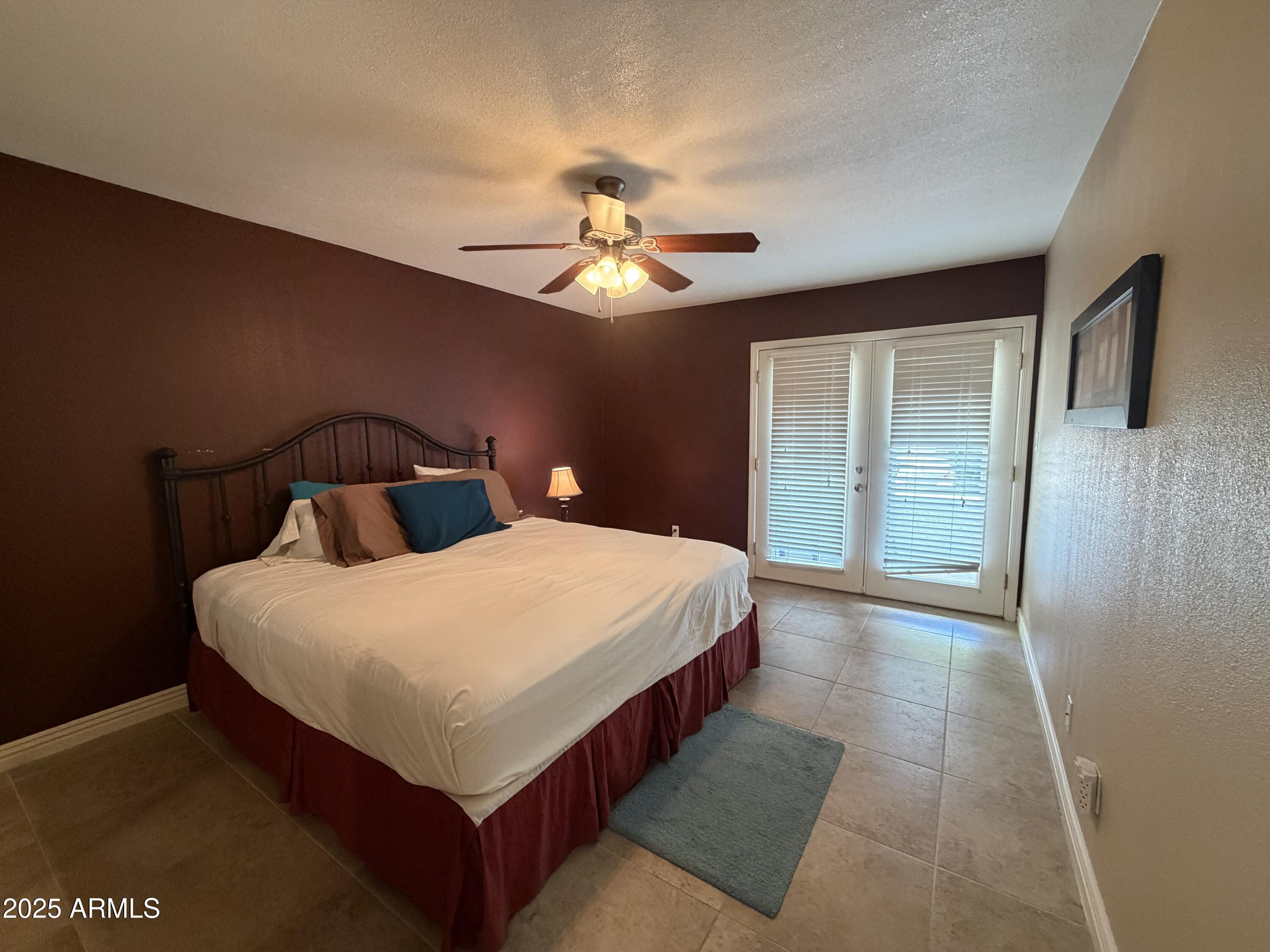 835 North Granite Reef Road, Unit 34 Scottsdale, AZ 85257 - Photo 6 of 13 a bedroom with a bed and a chandelier