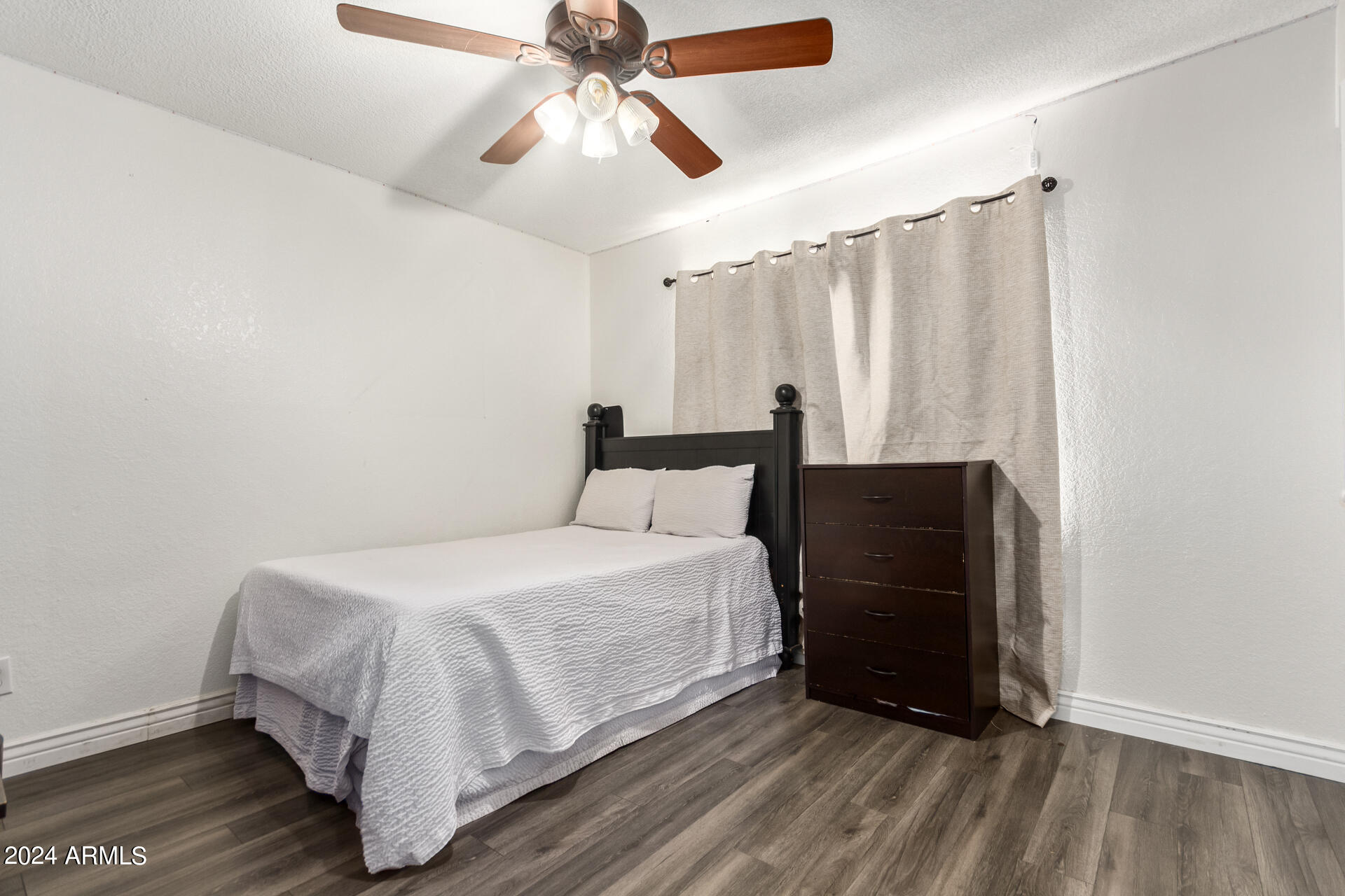328 East Harwell Road Gilbert, AZ 85234 - Photo 23 of 33 a bedroom with a bed and a chandelier