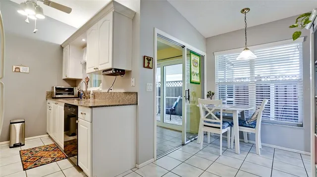 a kitchen with granite countertop a stove a sink and a refrigerator