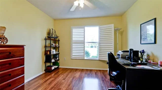 a view of a workspace with furniture and wooden floor