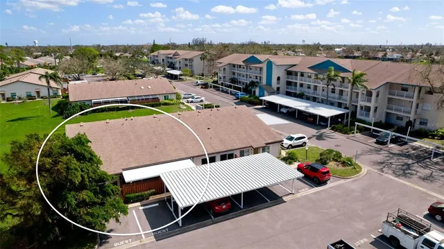 an aerial view of a house with a garden and swimming pool