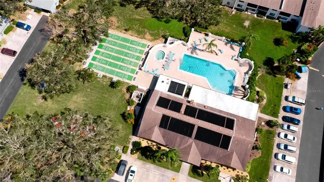 an aerial view of a house with a yard and lake view