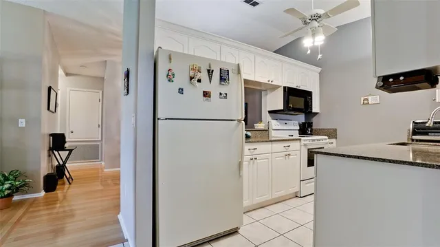 a white refrigerator freezer sitting inside of a kitchen