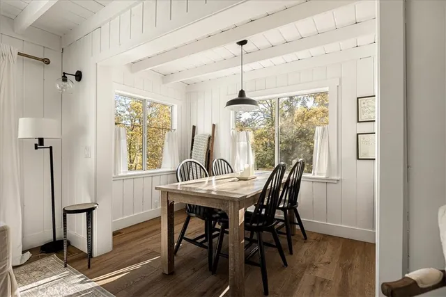 a view of a dining room with furniture window and wooden floor