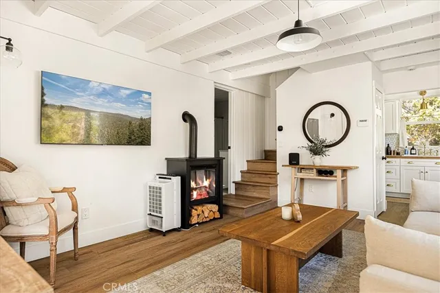a living room with furniture a clock and a flat screen tv