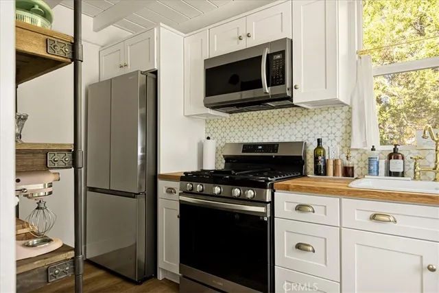 a kitchen with a stove microwave and refrigerator