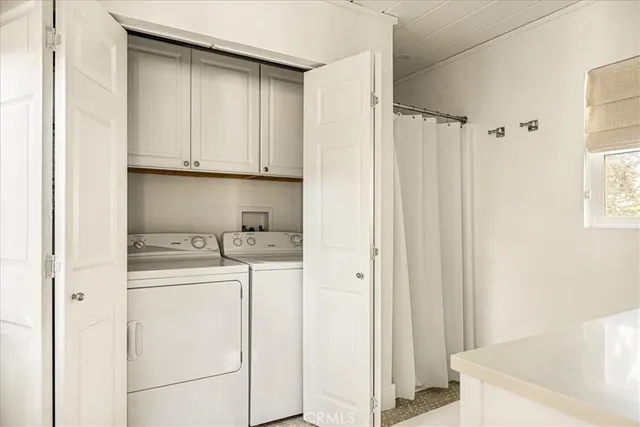 a kitchen with a white cabinets and white appliances