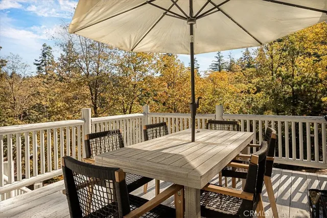 a view of balcony with furniture and umbrella
