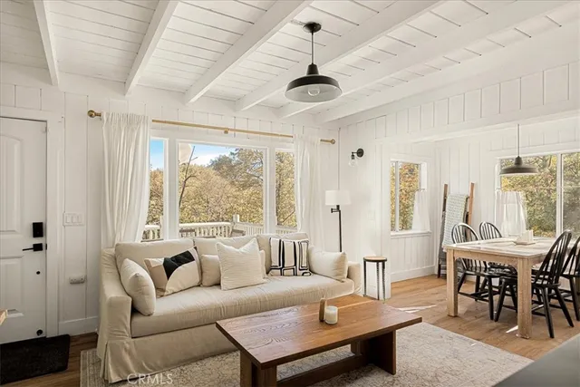 a living room with furniture a table and a large window