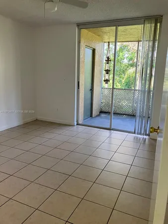 an empty room with sliding glass door and glass door