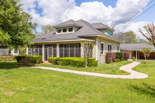 a front view of a house with a yard and porch