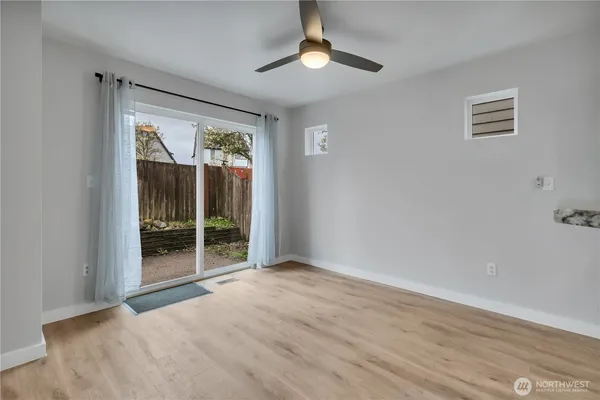 wooden floor in an empty room with a window