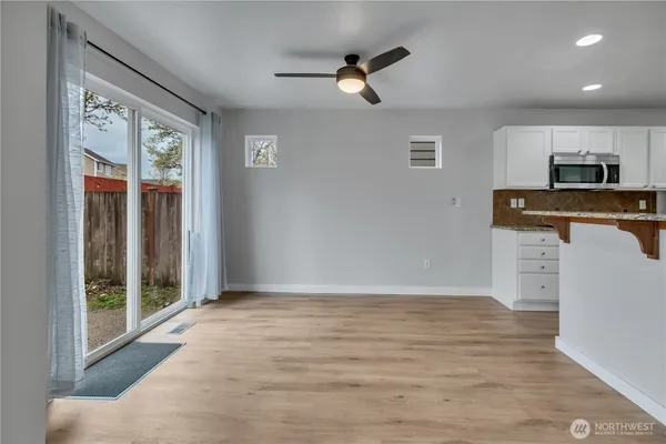 a view of workspace with wooden floor and ceiling fan