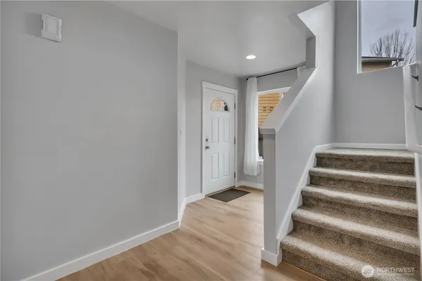 a view of entryway with wooden floor and stairs