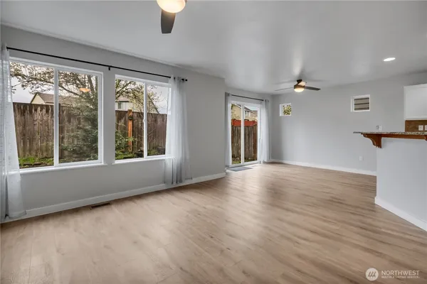 a view of livingroom with furniture wooden floor and windows