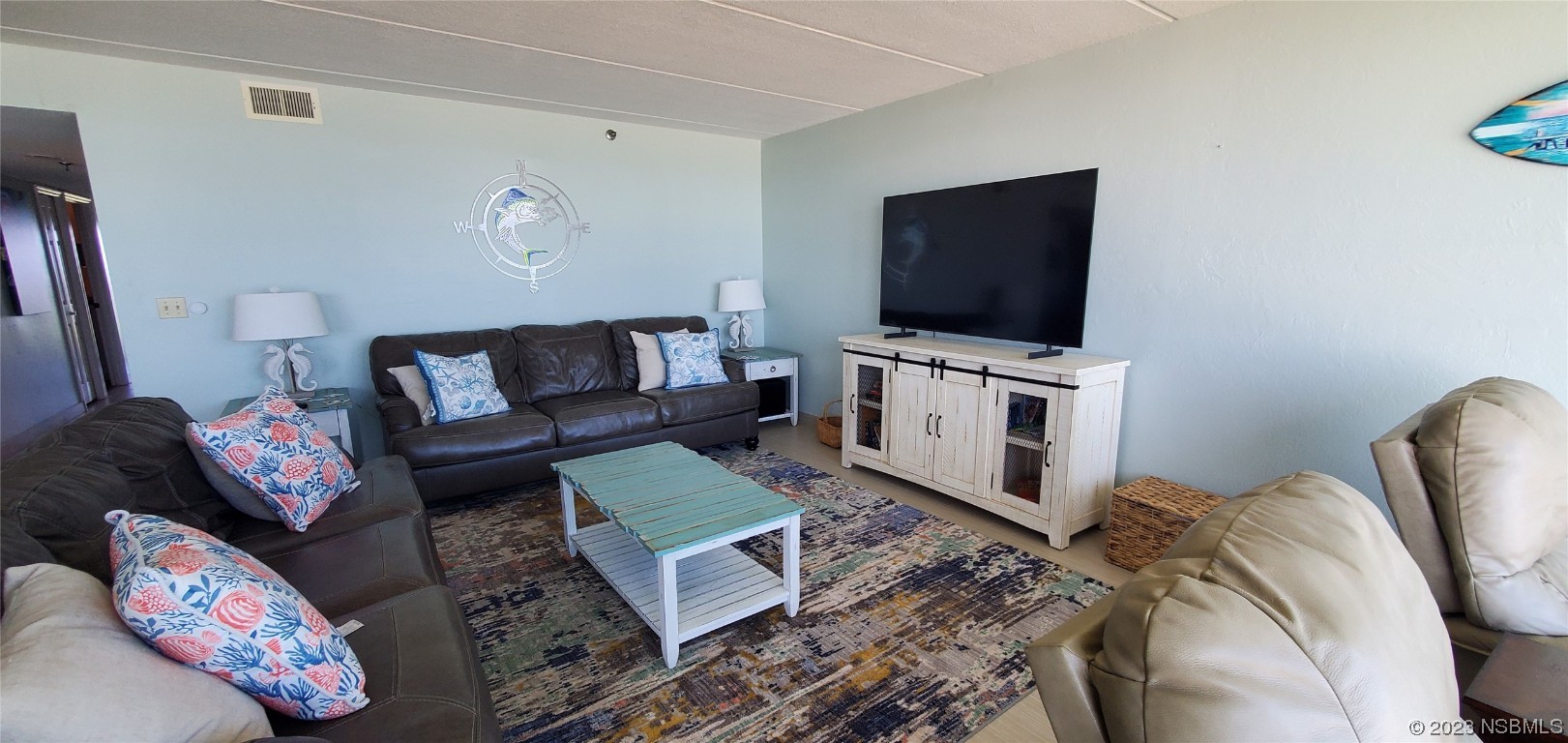 6727 Turtlemound Road, Unit 416 New Smyrna Beach, FL 32169 - Photo 12 of 67 a living room with furniture and a flat screen tv