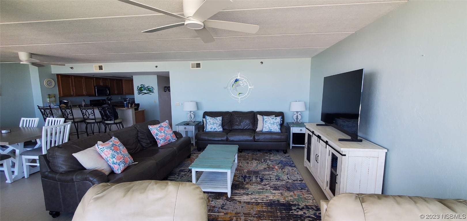 6727 Turtlemound Road, Unit 416 New Smyrna Beach, FL 32169 - Photo 13 of 67 a living room with furniture and a flat screen tv