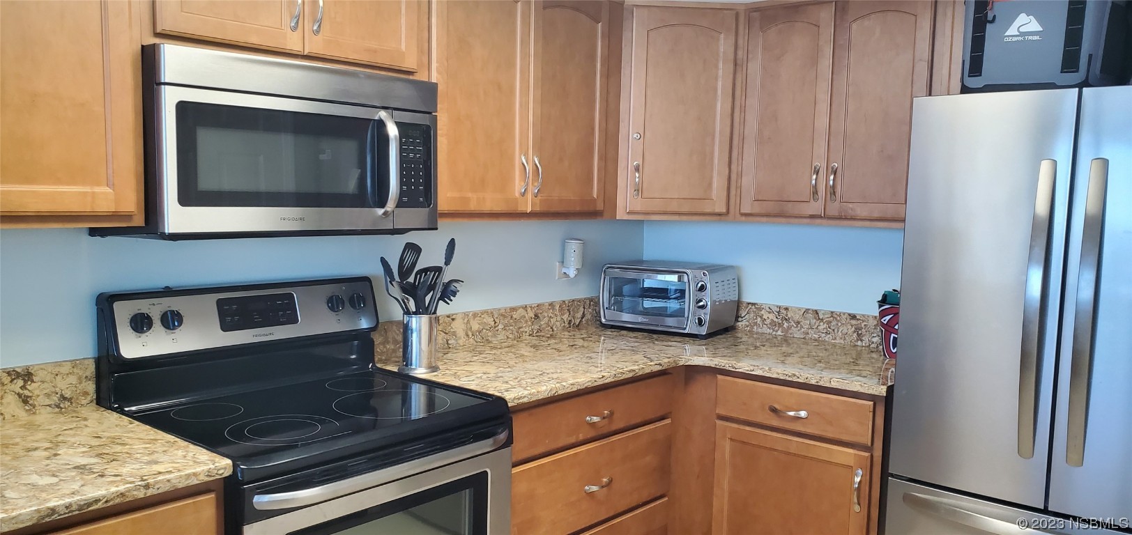 6727 Turtlemound Road, Unit 416 New Smyrna Beach, FL 32169 - Photo 19 of 67 a kitchen with granite countertop a stove and a microwave