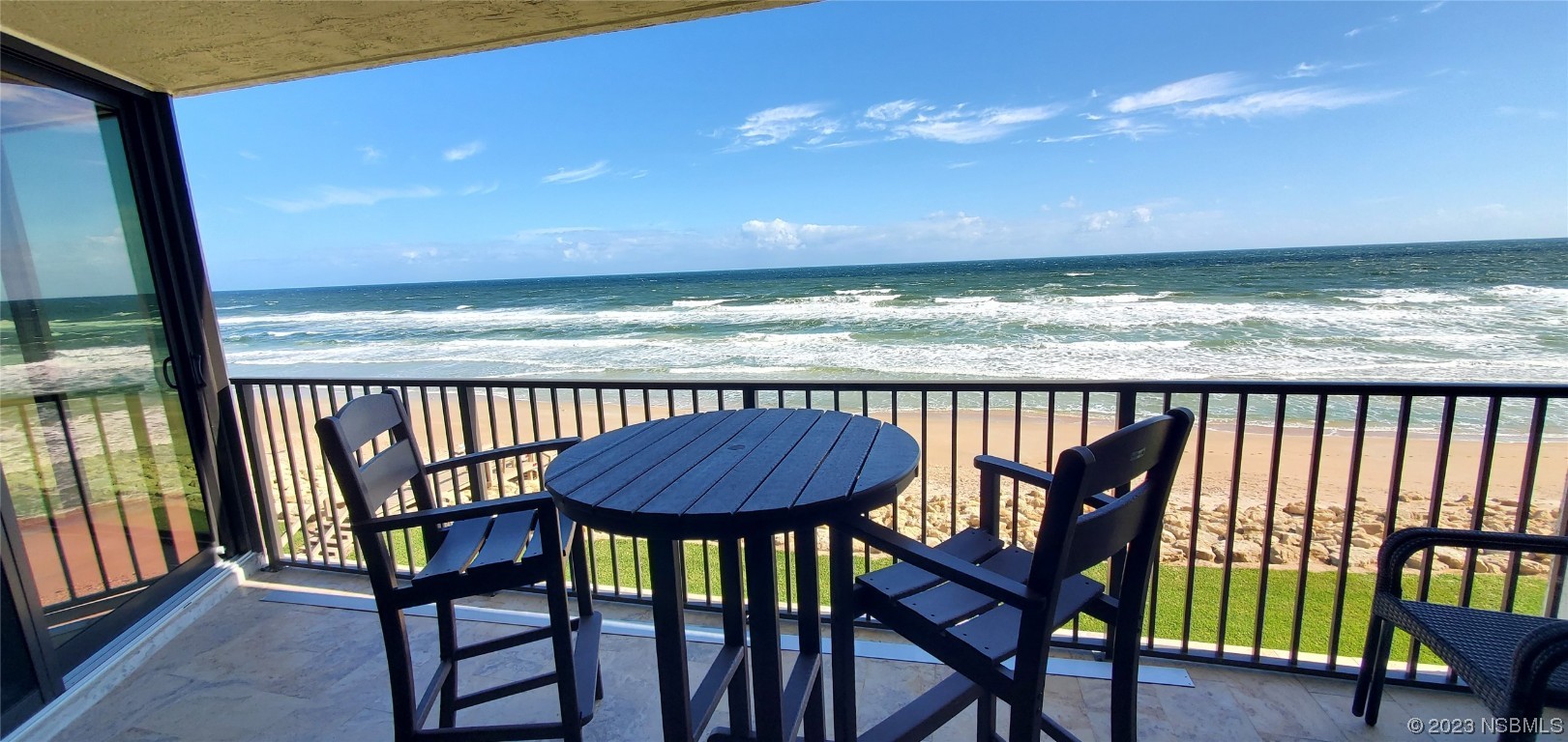 6727 Turtlemound Road, Unit 416 New Smyrna Beach, FL 32169 - Photo 29 of 67 a view of a chairs and table in the balcony