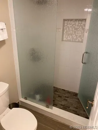 a bathroom with a granite countertop sink a toilet and a mirror