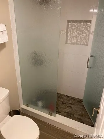 a bathroom with a granite countertop sink a toilet and a mirror