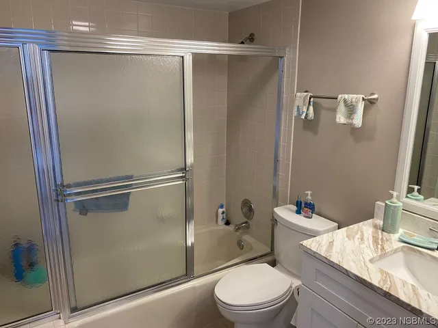 a view of a hallway with furniture and a window
