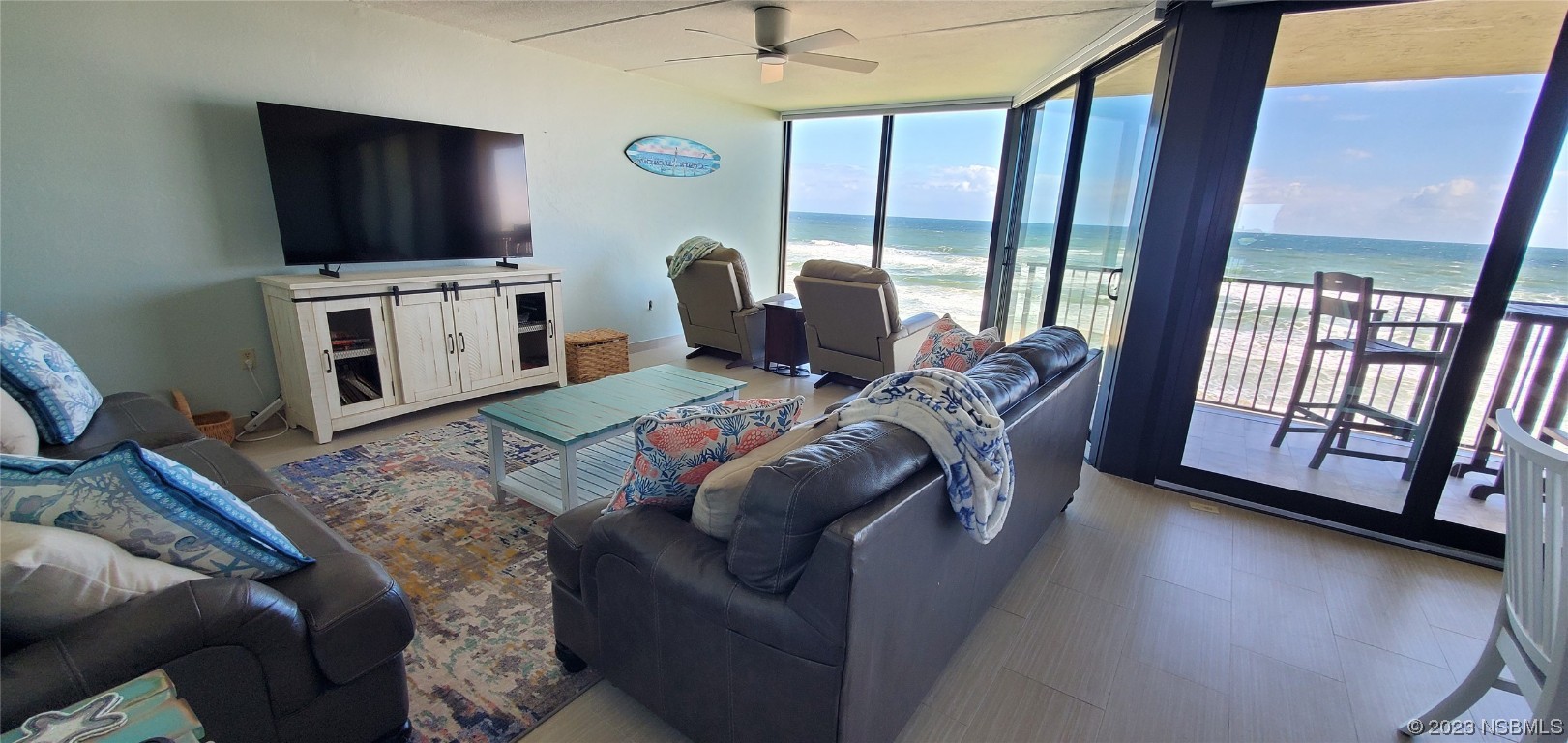 6727 Turtlemound Road, Unit 416 New Smyrna Beach, FL 32169 - Photo 5 of 67 a living room with furniture and a flat screen tv