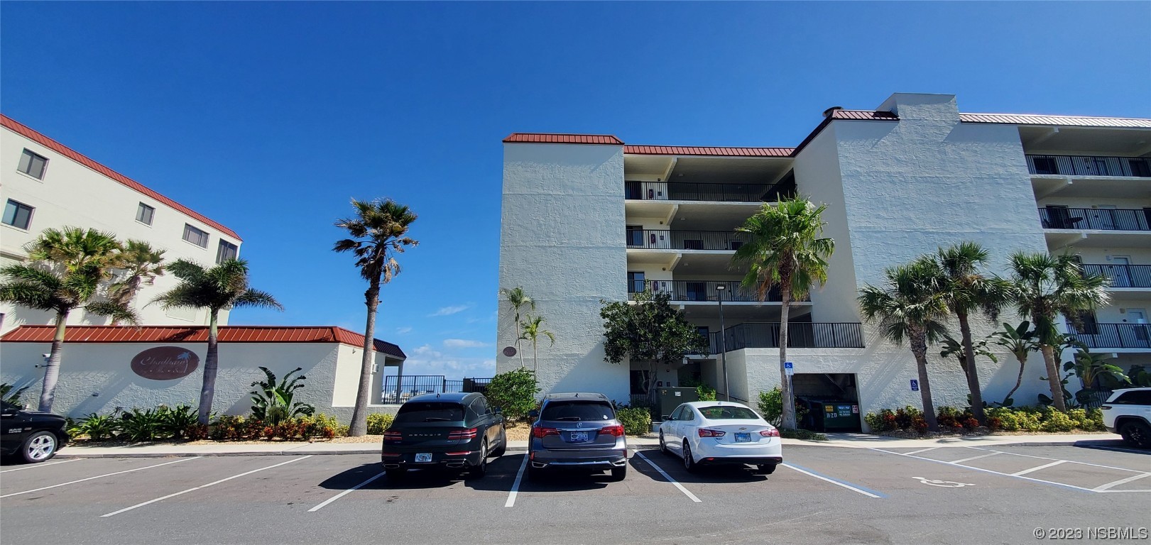 6727 Turtlemound Road, Unit 416 New Smyrna Beach, FL 32169 - Photo 66 of 67 a car parked in front of a building