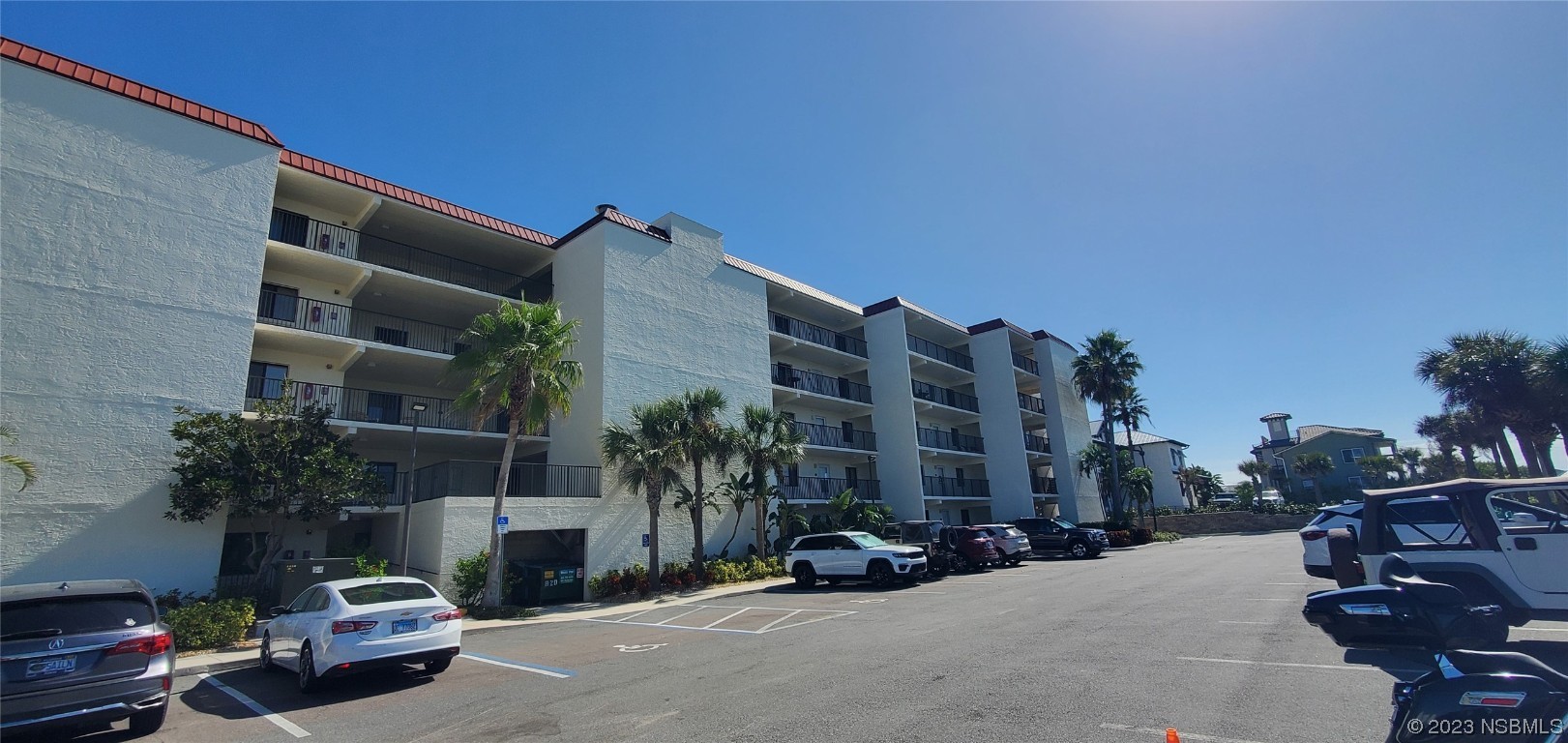6727 Turtlemound Road, Unit 416 New Smyrna Beach, FL 32169 - Photo 67 of 67 a view of car parked on the roadside