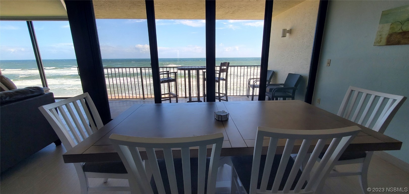 6727 Turtlemound Road, Unit 416 New Smyrna Beach, FL 32169 - Photo 10 of 67 a view of a dining room with furniture window and wooden floor
