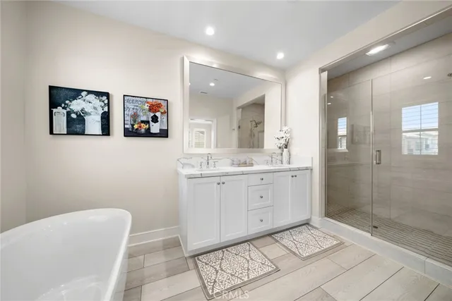 a spacious bathroom with a mirror a shower and a sink