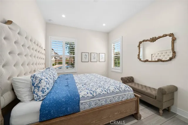 a bedroom with bed couch and window