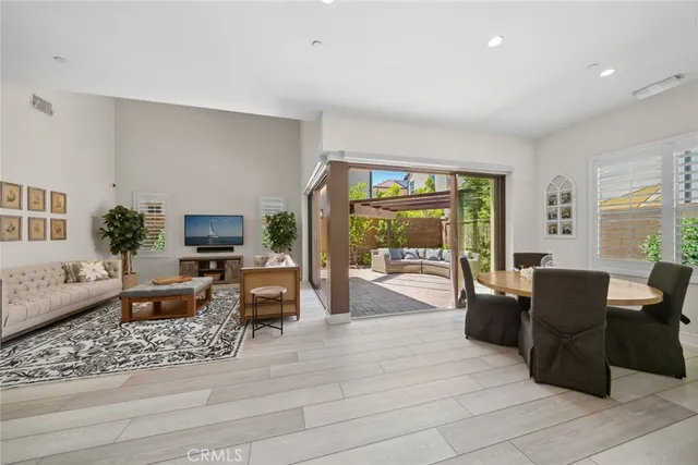 a living room with furniture large window and flat screen tv