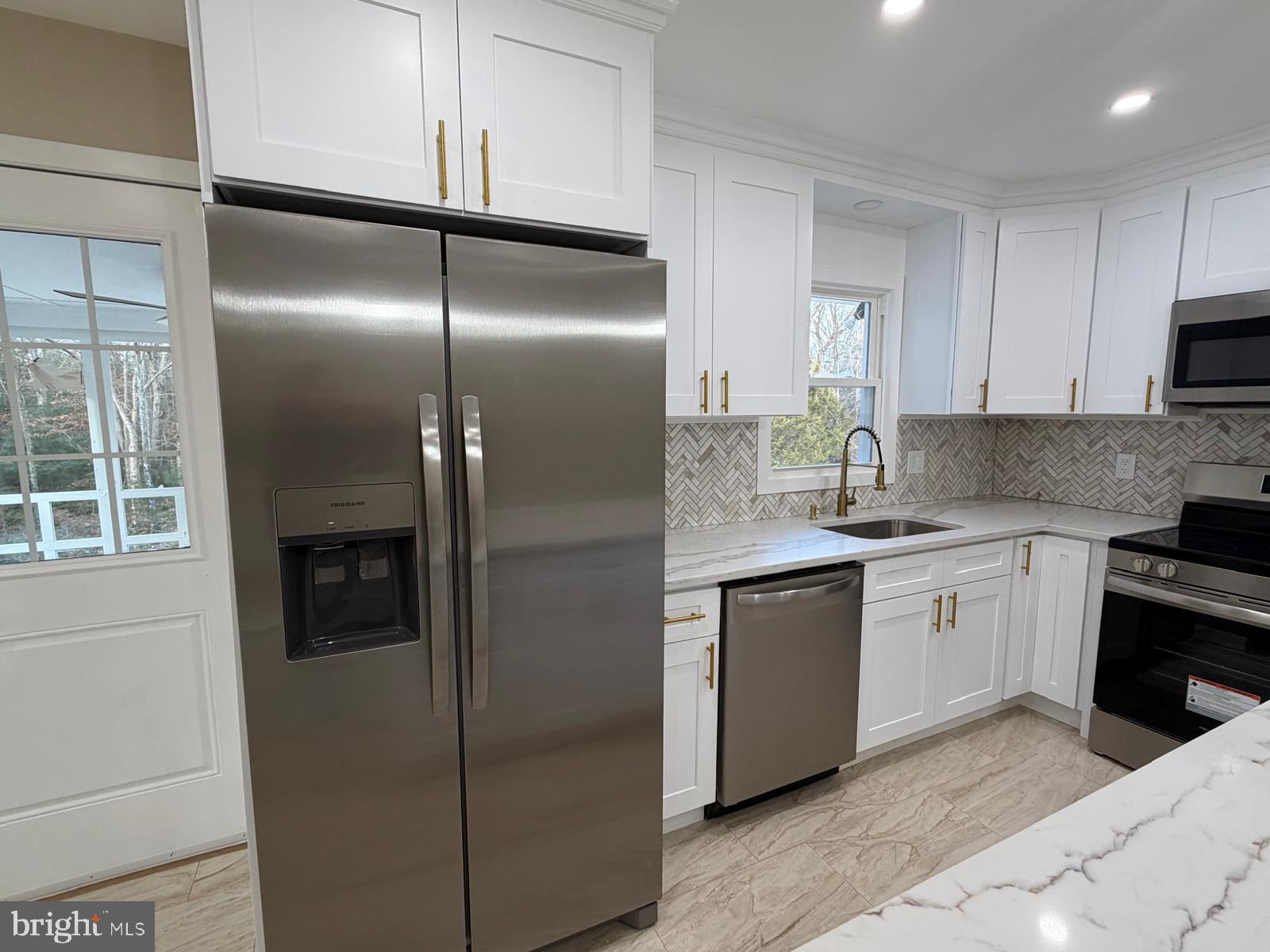 24 Rieck Avenue Millville, NJ 08332 - Photo 15 of 57 a kitchen with a refrigerator and a sink